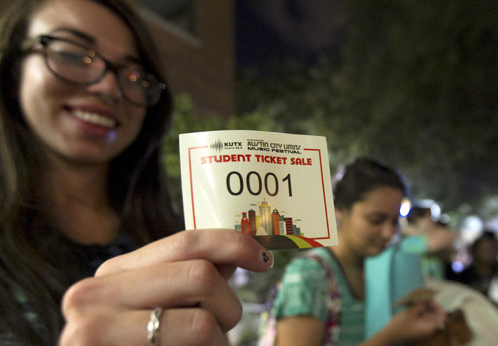 14 SEPTEMBER 2013: First in line, Ally Trevino, 20, holds up her 0001 ticket as she and her friends wait to buy weekend passes during the KUTX Austin City Limits Music Festival student ticket sale at The Belo Center for New Media's KUT Public Media Studios on the campus of the University of Texas in Austin, Texas, on Saturday, September 14, 2013. (RODOLFO GONZALEZ / AMERICAN-STATESMAN)