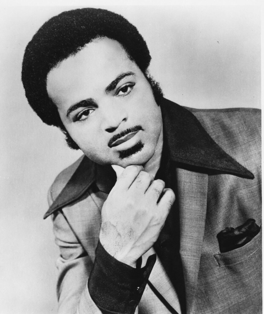 Z.Z. Hill poses for a portrait with his chin in his hand.