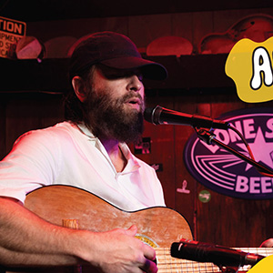 Alex Maas plays guitar and sings