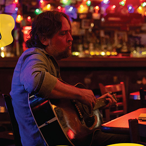 Hayes Carll plays guitar and sings