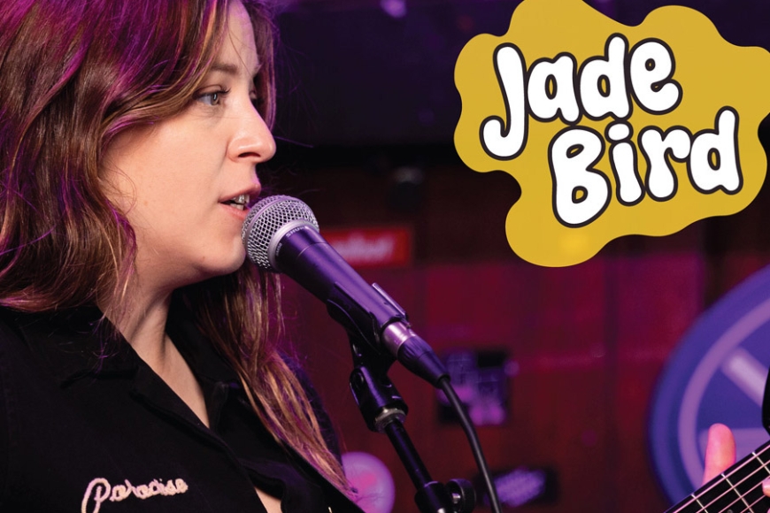 Jade Bird singing into a mic